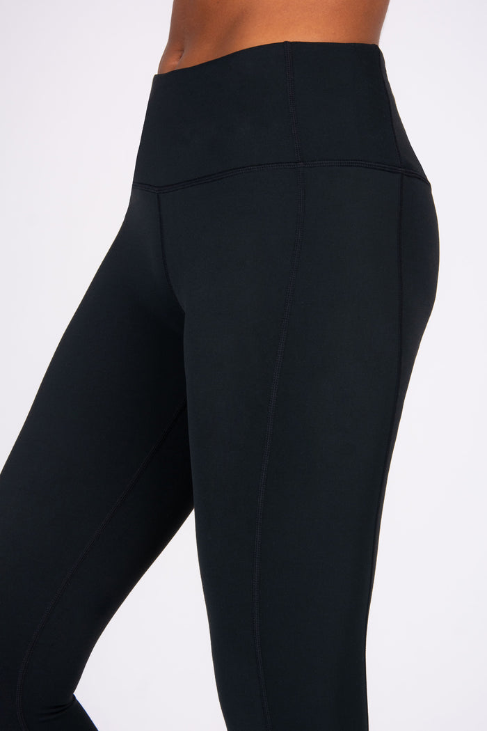 Black leggings worn by a person on a white background