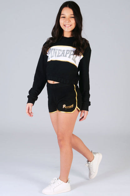 girl's black shorts with black sweater with silver Pineapple logo
