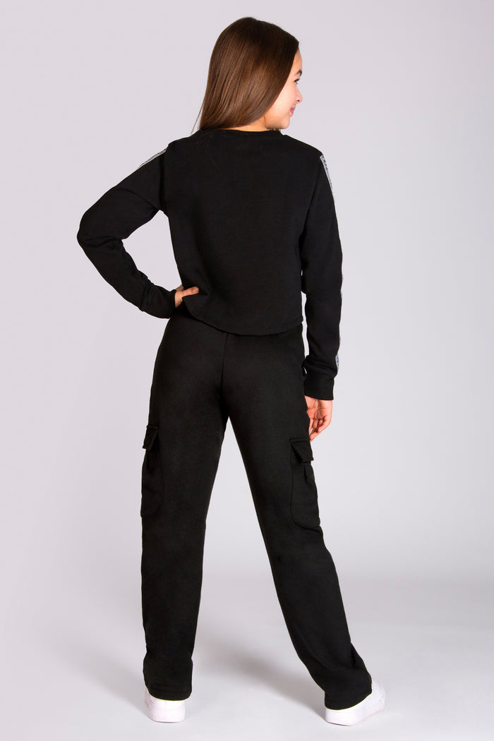 Girls' black crop sweater paired with wide leg cargo joggers