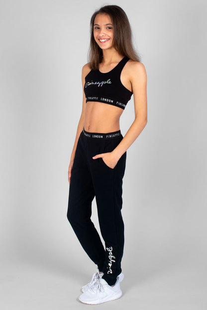Girl wearing logo black Script Crop Top and black Script Joggers