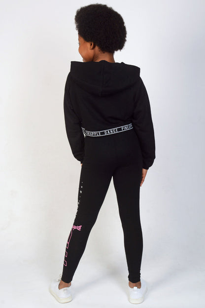 Girl wearing Black TNS Crop Hoodie and leggings