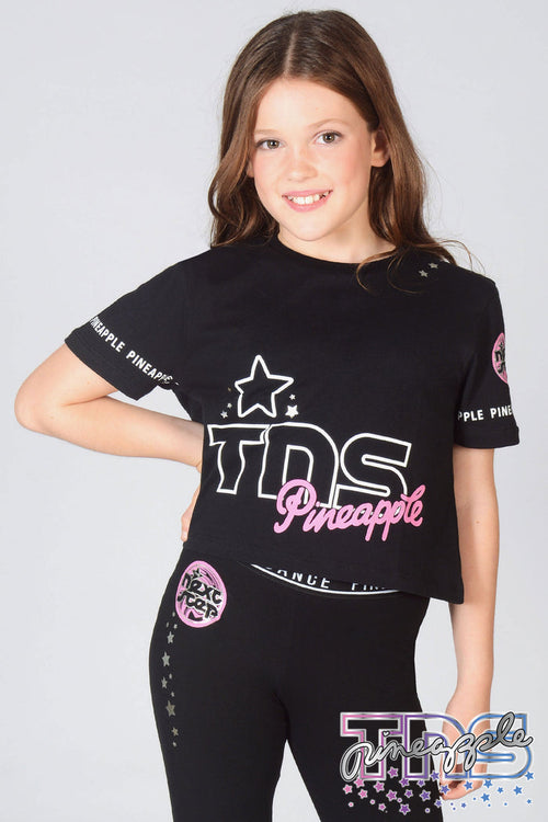 Girl wearing black The Next Step Crop T-Shirt with matching TNS Star Leggings in black.