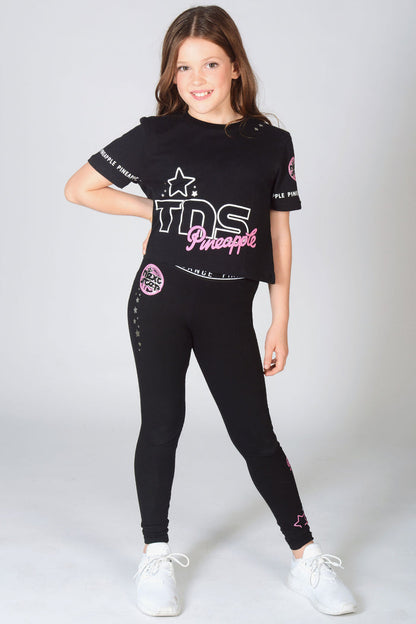 Young dancer wearing black TNS Crop T-Shirt with matching The Next Step Star Leggings in black.