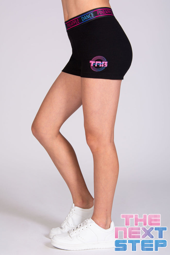 Girls' black hot pant shorts with The Next Step logo on the hip