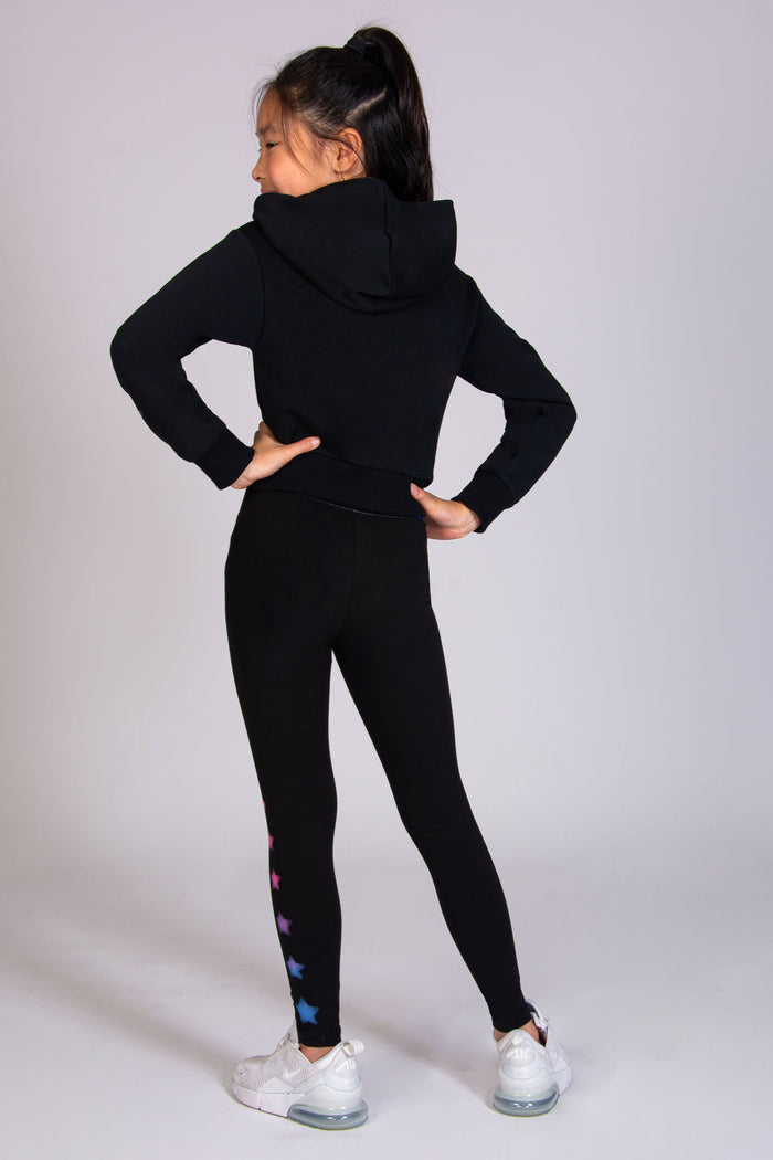 Girls' black leggings with pink and blue ombre stars and elasticated waistband by Pineapple.
