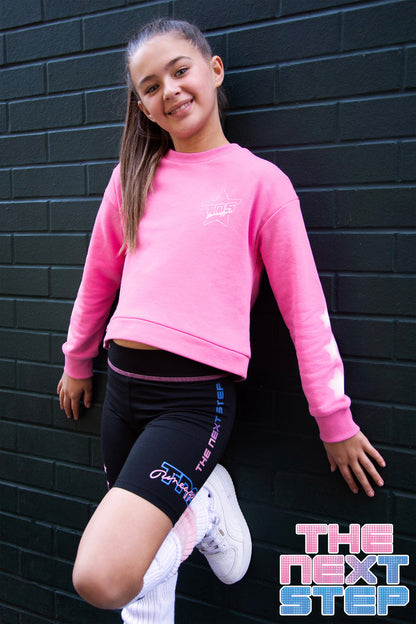 Pineapple x The Next Step sweater in pink for girls with diamanté and stars along the sleeves.