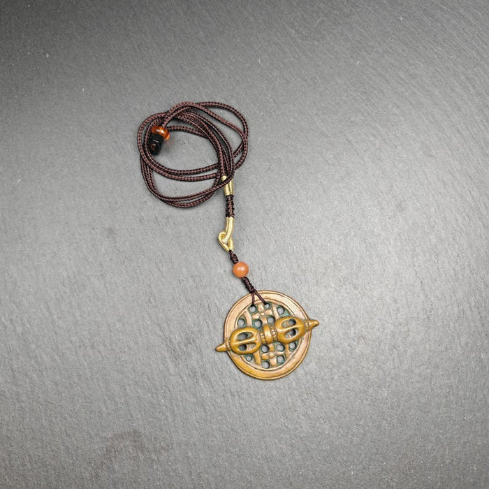 Tibetan talisman - Vajra Amulet - Dorje Pendant Badge - Tibetan Buddhist amulet, close-up detail