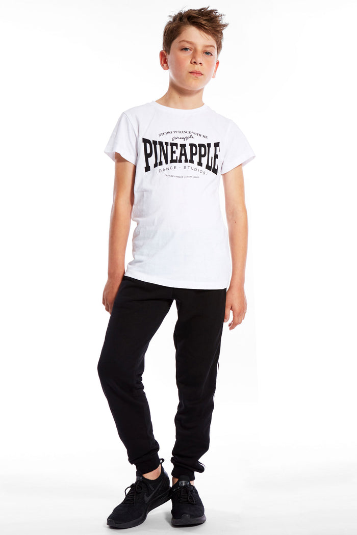 Boy wearing white Unisex Dance T-Shirt and track pants