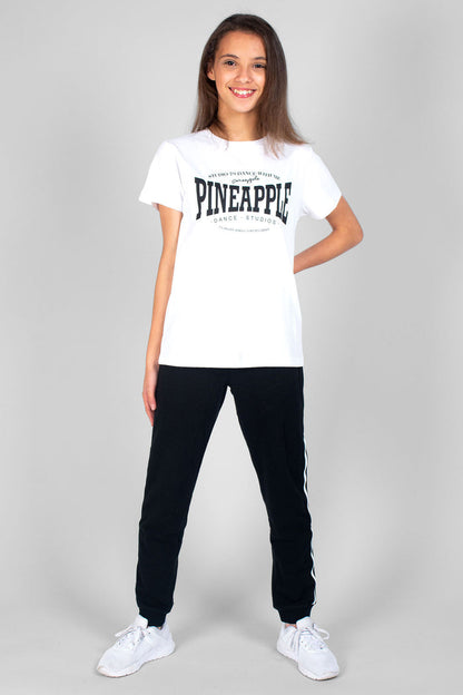 Girl wearing white Unisex Dance T-Shirt with black print logos and black Unixex Joggers