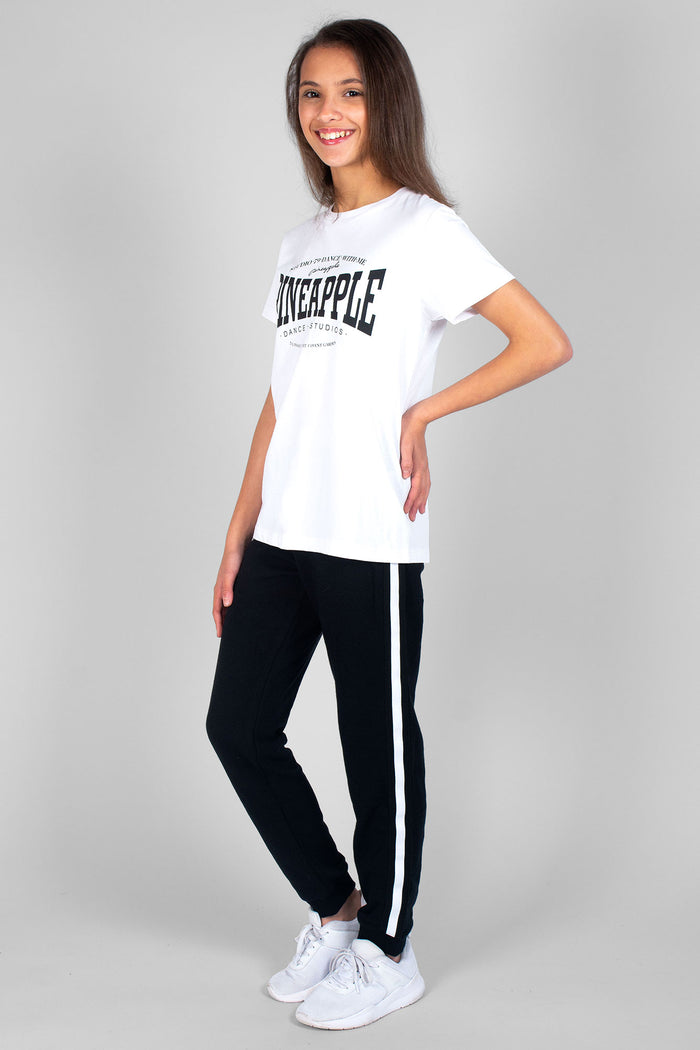 Girl wearing white Unisex Dance T-Shirt and black Stripe Joggers