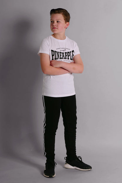 Boy wearing Black Unisex Kids' Stripe Joggers and white Unisex T-Shirt