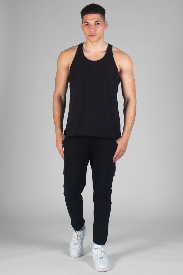 Man wearing black Unisex Vest and black trackpants