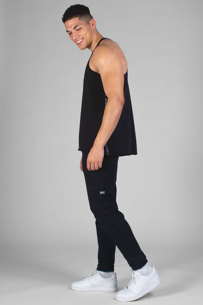 Man wearing black Unisex Vest with logo side stripe and black trackpants