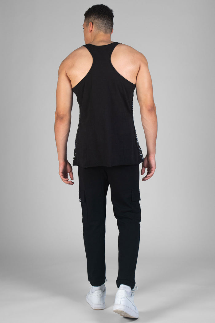 Man wearing black Unisex Vest and black cargo trackpants