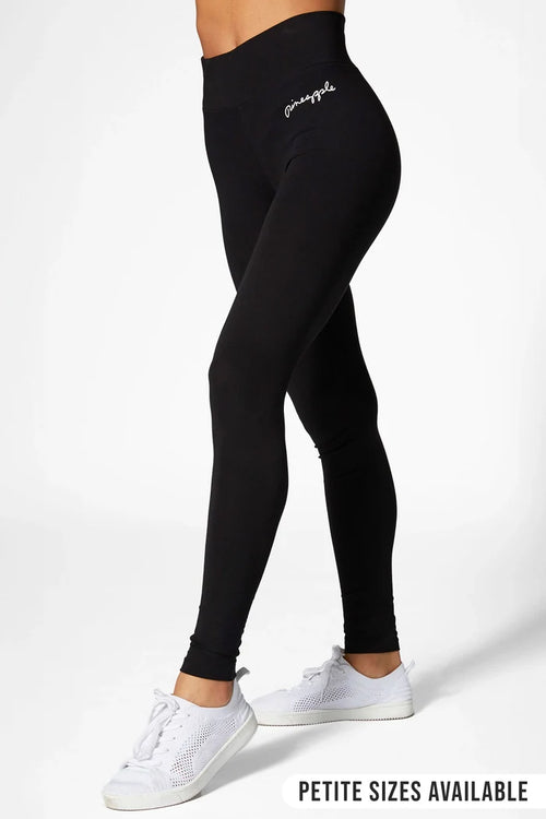 a woman wearing black cotton leggings on a white background
