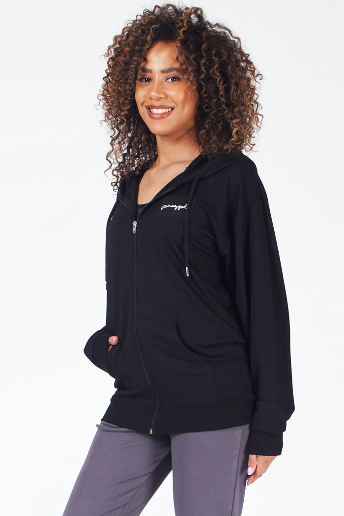 Woman wearing black zip front hoodie